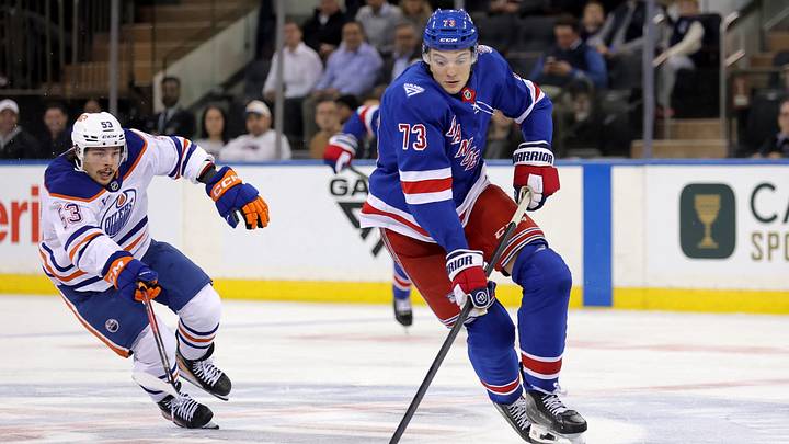 Oct 14, 2025; New York, New York, USA; New York Rangers center Matt Rempe (73) skates with the puck against Edmonton Oilers left wing Isaac Howard (53) during the third period at Madison Square Garden. Mandatory Credit: Brad Penner-Imagn Images