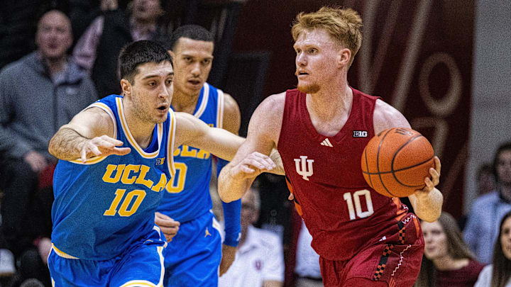Feb 14, 2025; Bloomington, Indiana, USA; Indiana Hoosiers forward Luke Goode (10) dribbles the ball while UCLA Bruins guard Lazar Stefanovic (10) defends in the second half at Simon Skjodt Assembly Hall. Mandatory Credit: Trevor Ruszkowski-Imagn Images