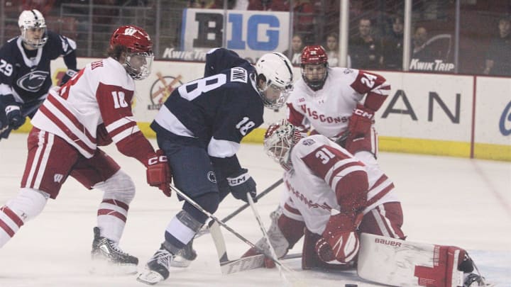 Wisconsin goaltender Kyle McClellan makes a save of a shot by Penn State's Aiden Fink at the Kohl Center in Madison, Wisconsin on Friday Dec. 8, 2023.