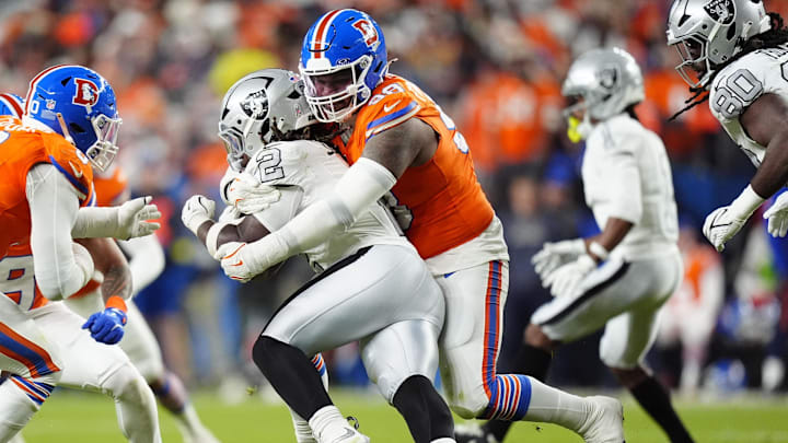 Nov 6, 2025; Denver, Colorado, USA; Denver Broncos defensive end John Franklin-Myers (98) makes a tackle on Las Vegas Raiders running back Ashton Jeanty (2) during the second half at Empower Field at Mile High. Mandatory Credit: Ron Chenoy-Imagn Images Nov 6, 2025; Denver, Colorado, USA; Denver Broncos defensive end John Franklin-Myers (98) makes a tackle on Las Vegas Raiders running back Ashton Jeanty (2) during the second half at Empower Field at Mile High. Mandatory Credit: Ron Chenoy-Imagn Images