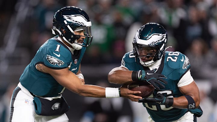 Nov 14, 2024; Philadelphia, Pennsylvania, USA; Philadelphia Eagles quarterback Jalen Hurts (1) hands off to running back Saquon Barkley (26) during the first quarter against the Washington Commanders at Lincoln Financial Field. Mandatory Credit: Bill Streicher-Imagn Images