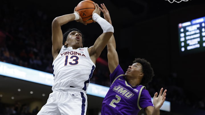 Virginia guard Ryan Dunn tried to get a shot off under the heavy guard of then-James Madison guard Tyree Ihenacho (2), now of the UW.