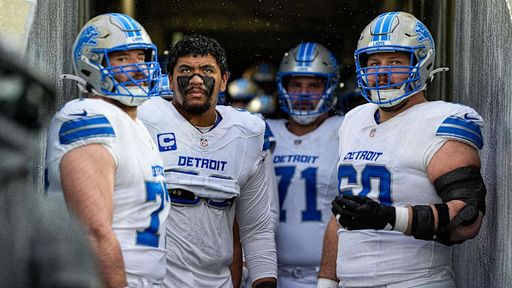 From left, Detroit Lions center Frank Ragnow (77), offensive tackle Penei Sewell (58), guard Kevin Zeitler (71), and guard Graham Glasgow (60) look on from the visiting team tunnel before taking the field for the first half against Green Bay Packers at Lambeau Field in Green Bay, Wis., on Sunday, Nov. 3, 2024.