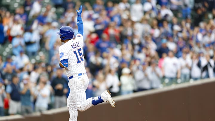 Apr 18, 2025; Chicago, Illinois, USA; Chicago Cubs catcher Carson Kelly (15) rounds the bases after hitting a three-run home run against the Arizona Diamondbacks during the eight inning at Wrigley Field. 