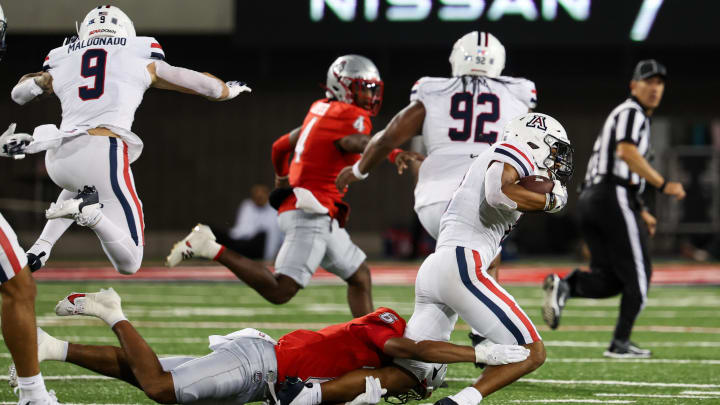 Aug 31, 2024; Tucson, Arizona, USA; Arizona Wildcats defensive back Treydan Stukes (2) run and gets tackled by New Mexico Lobos running back Eli Sanders (6) during third quarter at Arizona Stadium. Aug 31, 2024; Tucson, Arizona, USA; Arizona Wildcats defensive back Treydan Stukes (2) run and gets tackled by New Mexico Lobos running back Eli Sanders (6) during third quarter at Arizona Stadium.