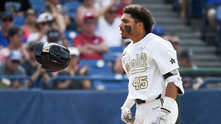 Vanderbilt batter Alan Espinal flips his helmet after hitting a home run against Florida Saturday,