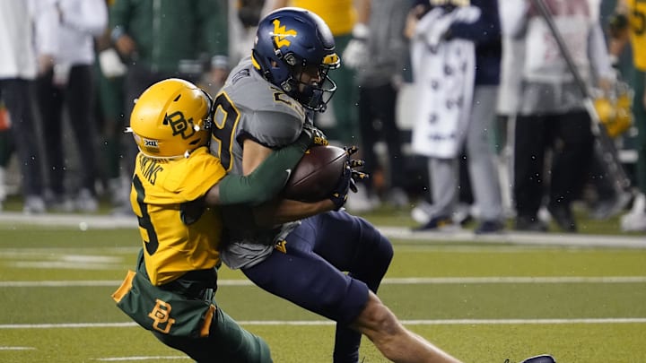Nov 25, 2023; Waco, Texas, USA; West Virginia Mountaineers wide receiver Preston Fox (29) is tackled by Baylor Bears cornerback Caden Jenkins (19) during the first half at McLane Stadium. Mandatory Credit: Raymond Carlin III-Imagn Images