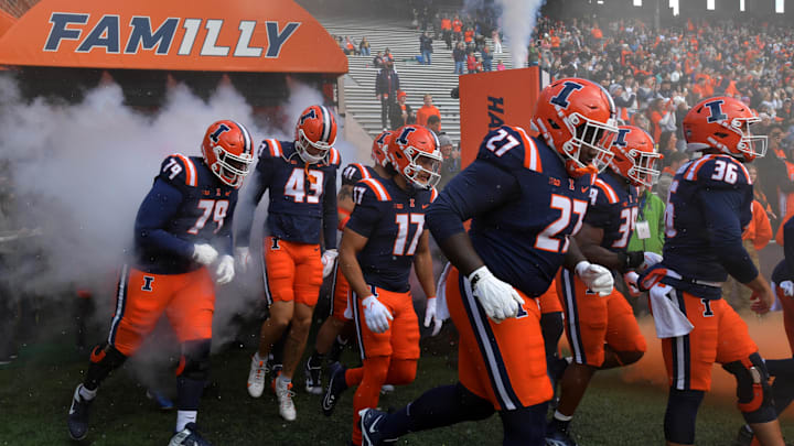 Nov 16, 2024; Champaign, Illinois, USA;  Illinois fighting Illini players take the field against the Michigan State Spartans at Memorial Stadium. Mandatory Credit: Ron Johnson-Imagn Images