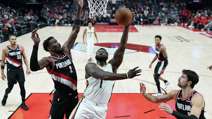 Oct 25, 2024; Portland, Oregon, USA; New Orleans Pelicans power forward Zion Williamson (1) shoots the ball against Portland Trail Blazers center Deandre Ayton (2) during the second half at Moda Center. Mandatory Credit: Soobum Im-Imagn Images