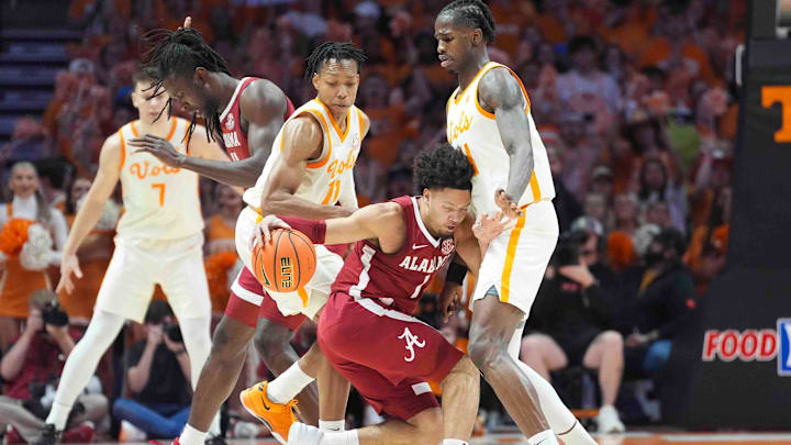 Alabama guard Mark Sears (1) dribbles into Tennessee's Felix Okpara (34) during a men’s college basketball game between Tennessee and Alabama at Thompson-Boling Arena at Food City Center, Saturday, March 1, 2025.