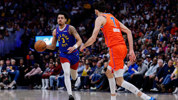 Feb 1, 2026; Denver, Colorado, USA; Denver Nuggets guard Julian Strawther (3) controls the ball as Oklahoma City Thunder center Chet Holmgren (7) guards in the fourth quarter at Ball Arena.