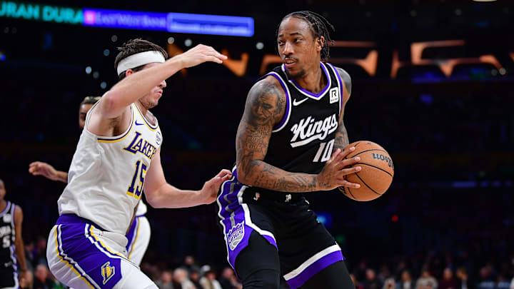 Dec 28, 2024; Los Angeles, California, USA; Sacramento Kings forward DeMar DeRozan (10) moves the ball against Los Angeles Lakers guard Austin Reaves (15) during the first half at Crypto.com Arena. Mandatory Credit: Gary A. Vasquez-Imagn Images
