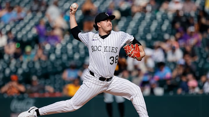 Aug 2, 2025; Denver, Colorado, USA; Colorado Rockies relief pitcher Victor Vodnik (38) pitches in the eighth inning against the Pittsburgh Pirates at Coors Field. 