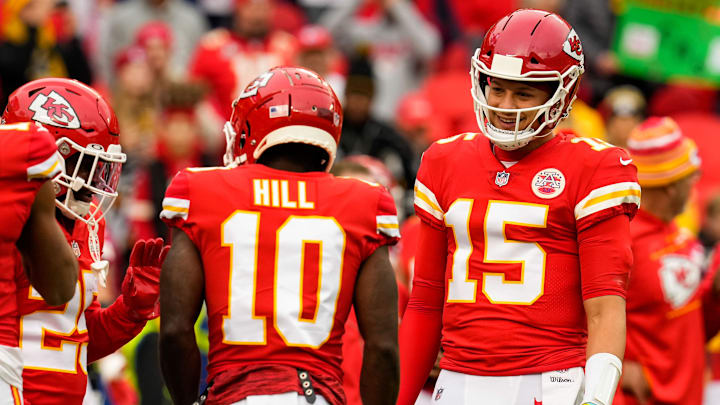 Dec 26, 2021; Kansas City, Missouri, USA; Kansas City Chiefs quarterback Patrick Mahomes (15) talks with Kansas City Chiefs wide receiver Tyreek Hill (10) and running back Clyde Edwards-Helaire (25) before the game against the Pittsburgh Steelers at GEHA Field at Arrowhead Stadium. Mandatory Credit: Jay Biggerstaff-Imagn Images