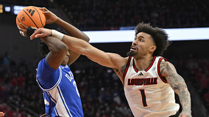 Jan 6, 2026; Louisville, Kentucky, USA; Louisville Cardinals guard J'vonne Hadley (1) battles Duke Blue Devils center Patrick Ngongba (21) for a rebound during the first half at KFC Yum! Center. Mandatory Credit: Jamie Rhodes-Imagn Images Jan 6, 2026; Louisville, Kentucky, USA; Louisville Cardinals guard J'vonne Hadley (1) battles Duke Blue Devils center Patrick Ngongba (21) for a rebound during the first half at KFC Yum! Center. Mandatory Credit: Jamie Rhodes-Imagn Images