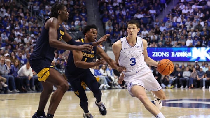 Mar 1, 2025; Provo, Utah, USA; Brigham Young Cougars guard Egor Demin (3) drives to the basket against West Virginia Mountaineers guard Joseph Yesufu (1) and center Eduardo Andre (0) during the first half at Marriott Center. Mandatory Credit: Rob Gray-Imagn Images Mar 1, 2025; Provo, Utah, USA; Brigham Young Cougars guard Egor Demin (3) drives to the basket against West Virginia Mountaineers guard Joseph Yesufu (1) and center Eduardo Andre (0) during the first half at Marriott Center. Mandatory Credit: Rob Gray-Imagn Images