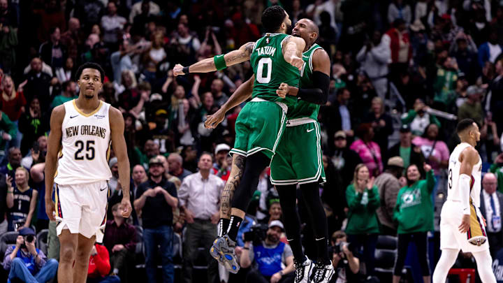 Jan 31, 2025; New Orleans, Louisiana, USA; Boston Celtics forward Jayson Tatum (0) chest bumps center Al Horford (42) after he makes the go ahead basket to give them the lead against the New Orleans Pelicans with .2 seconds left on the clock during the second half at Smoothie King Center. Mandatory Credit: Stephen Lew-Imagn Images