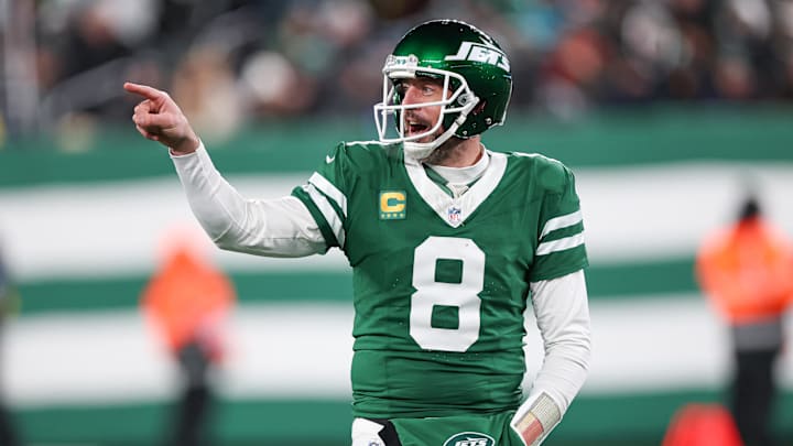 New York Jets quarterback Aaron Rodgers gestures towards the Miami Dolphins bench