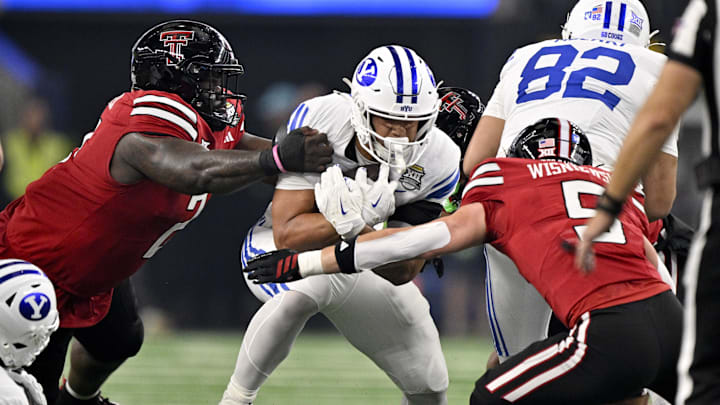 Dec 6, 2025; Arlington, TX, USA; BYU Cougars running back LJ Martin (4) is tackled by Texas Tech Red Raiders defensive back Cole Wisniewski (5) during the first half at AT&T Stadium. Mandatory Credit: Jerome Miron-Imagn Images