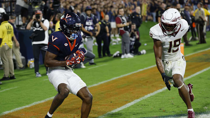 Sep 26, 2025; Charlottesville, Virginia, USA; Virginia Cavaliers wide receiver Trell Harris (11) catches a two point conversion as Florida State Seminoles defensive back Jerry Wilson (19) defends in the second overtime period at Scott Stadium. Mandatory Credit: Geoff Burke-Imagn Images