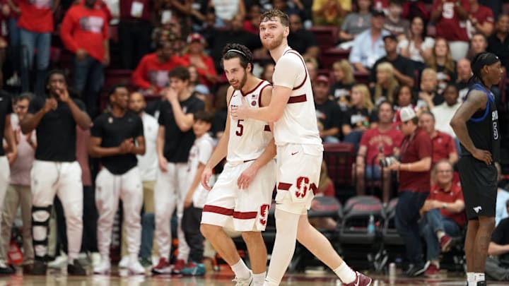 Feb 28, 2026; Stanford, California, USA; Stanford Cardinal guard Benny Gealer (5) and forward Aidan Cammann (center right) celebrate during the second half against the Southern Methodist University Mustangs at Maples Pavilion. Mandatory Credit: Darren Yamashita-Imagn Images