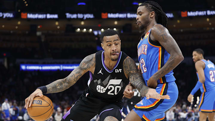 Jan 22, 2025; Oklahoma City, Oklahoma, USA; Utah Jazz forward John Collins (20) drives against Oklahoma City Thunder guard Cason Wallace (22) during the second half at Paycom Center. Mandatory Credit: Alonzo Adams-Imagn Images