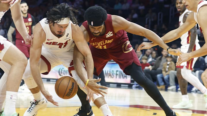 Nov 10, 2025; Miami, Florida, USA;  Miami Heat forward Jaime Jaquez Jr. (11) and Cleveland Cavaliers center Jarrett Allen (31) fight for a loose ball during the first period at Kaseya Center. Mandatory Credit: Rhona Wise-Imagn Images