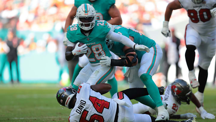 Miami Dolphins running back De'Von Achane (28) is tackled by Tampa Bay Buccaneers linebacker Lavonte David (54) during the second quarter at Hard Rock Stadium. Miami Dolphins running back De'Von Achane (28) is tackled by Tampa Bay Buccaneers linebacker Lavonte David (54) during the second quarter at Hard Rock Stadium.