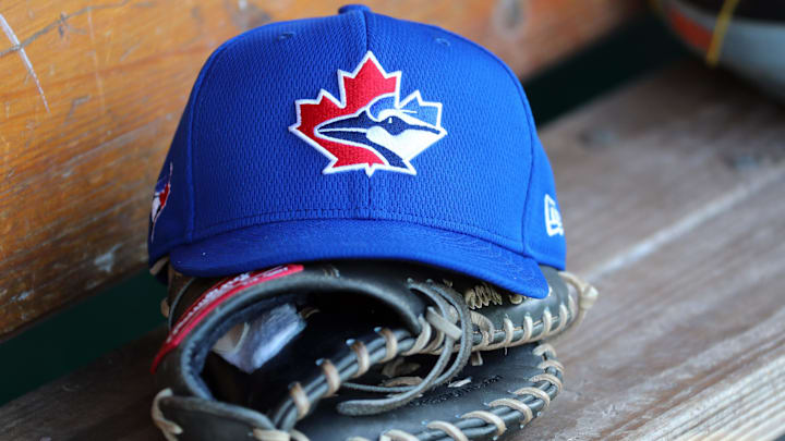 Feb 23, 2020; Fort Myers, Florida, USA; A detail veil of Toronto Blue Jays spring training hat and glove against the Minnesota Twins at CenturyLink Sports Complex. Feb 23, 2020; Fort Myers, Florida, USA; A detail veil of Toronto Blue Jays spring training hat and glove against the Minnesota Twins at CenturyLink Sports Complex.