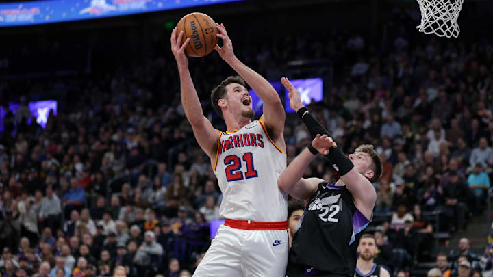 Feb 5, 2025; Salt Lake City, Utah, USA;  Golden State Warriors center Quinten Post (21) shoots the ball over Utah Jazz forward Kyle Filipowski (22) during the second half at Delta Center. Mandatory Credit: Chris Nicoll-Imagn Images
