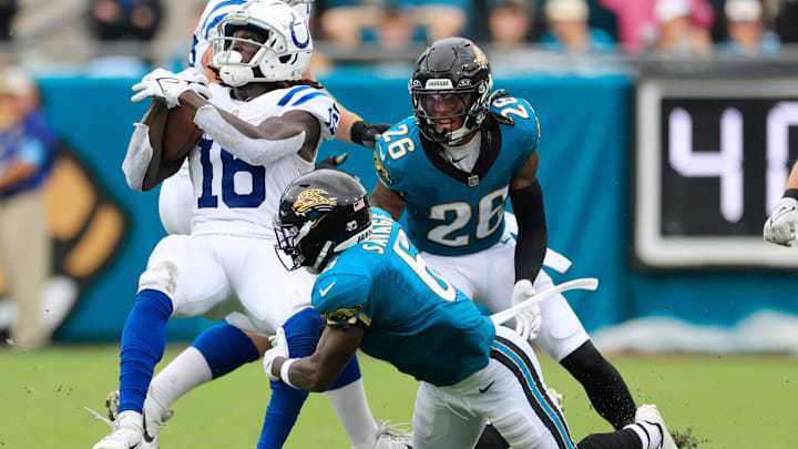 Indianapolis Colts wide receiver Ashton Dulin (16) is tackled by Jacksonville Jaguars safety Darnell Savage (6) as safety Antonio Johnson (26) looks on during the third quarter of an NFL football matchup Sunday, Oct. 6, 2024 at EverBank Stadium in Jacksonville, Fla. The Jaguars edged the Colts on a field goal 37-34. [Corey Perrine/Florida Times-Union]