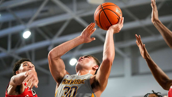 Montverde Academy Eagles guard Dante Allen (30) shoots a lay up while usrrounded by Archbishop Carroll Patriots defenders during the fourth quarter of the first round of the 51st annual City of Palms Classic at Suncoast Credit Union Arena in Fort Myers, Fla., on Wednesday, Dec. 18, 2024.
