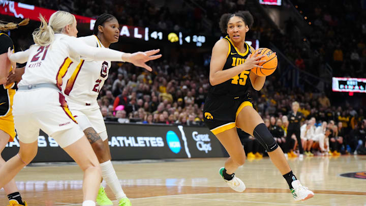Iowa Hawkeyes forward Hannah Stuelke (45) controls the ball against South Carolina Gamecocks guard Bree Hall (23) in the second half in the finals of the Final Four of the womens 2024 NCAA Tournament at Rocket Mortgage FieldHouse. Iowa Hawkeyes forward Hannah Stuelke (45) controls the ball against South Carolina Gamecocks guard Bree Hall (23) in the second half in the finals of the Final Four of the womens 2024 NCAA Tournament at Rocket Mortgage FieldHouse.