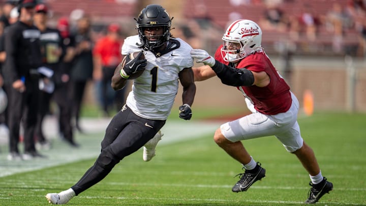 Oct 26, 2024; Stanford, California, USA;  Wake Forest Demon Deacons running back Demond Claiborne (1) breaks a tackle by Stanford Cardinal linebacker Tristan Sinclair (8) during the second quarter fr a first down at Stanford Stadium. Mandatory Credit: Neville E. Guard-Imagn Images