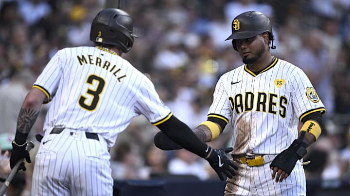 Aug 13, 2024; San Diego, California, USA; San Diego Padres designated hitter Luis Arraez (4) is congratulated by center fielder Jackson Merrill (3) after scoring a run against the Pittsburgh Pirates during the first inning at Petco Park. Mandatory Credit: Orlando Ramirez-Imagn Images