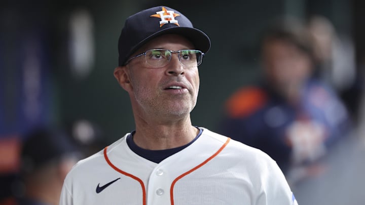 Apr 14, 2026; Houston, Texas, USA; Houston Astros manager Joe Espada looks on from the dugout before the game against the Colorado Rockies at Daikin Park. 