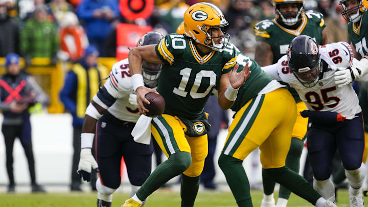Jan 5, 2025; Green Bay, Wisconsin, USA;  Green Bay Packers quarterback Jordan Love (10) scrambles to avoid pressure during the first quarter against the Chicago Bears at Lambeau Field. Mandatory Credit: Jeff Hanisch-Imagn Images