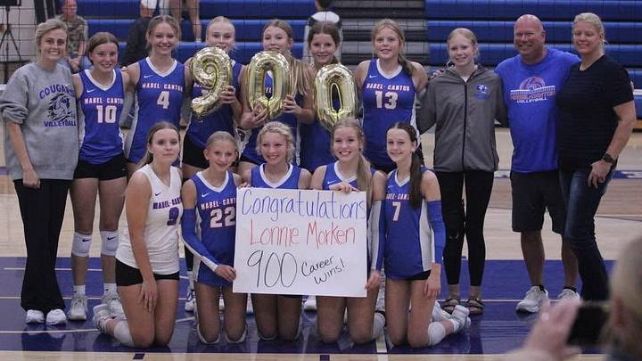 Mabel-Canton head volleyball coach Lonnie Morken (second from the right) and his team celebrating his 900th career win after the Cougrs defeated Coon Rapids on Sept. 19.