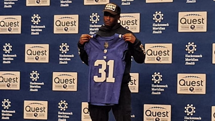 New York Giants second-round draft pick Tyler Nubin holds up his new jersey number assignment. New York Giants second-round draft pick Tyler Nubin holds up his new jersey number assignment.