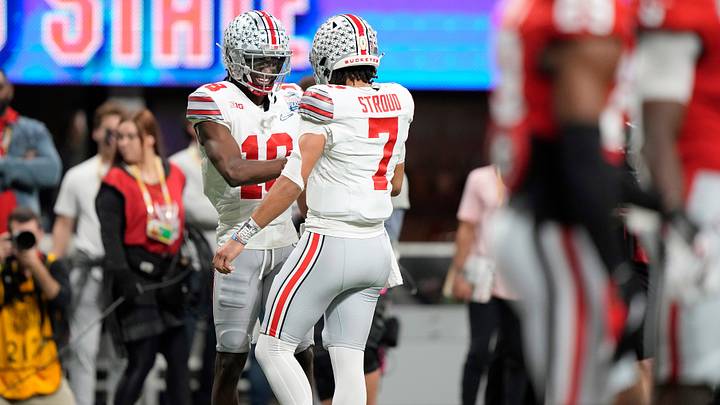 Dec 31, 2022; Atlanta, Georgia, USA; Ohio State Buckeyes wide receiver Marvin Harrison Jr. (18) celebrates his touchdown with quarterback C.J. Stroud (7) against Georgia Bulldogs during the second quarter of the Peach Bowl in the College Football Playoff semifinal at Mercedes-Benz Stadium.

Osu22uga Kwr 30
