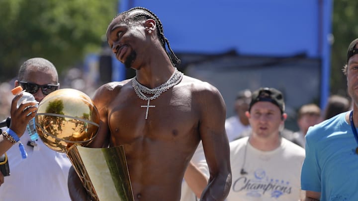 Oklahoma City Thunder guard Shai Gilgeous-Alexander carries the Larry O'Brien trophy as he celebrates with fans as the  Oklahoma City Thunder celebrate their first NBA Finals title win with a champions parade throughout downtown Oklahoma City on Tuesday, June 24, 2025.