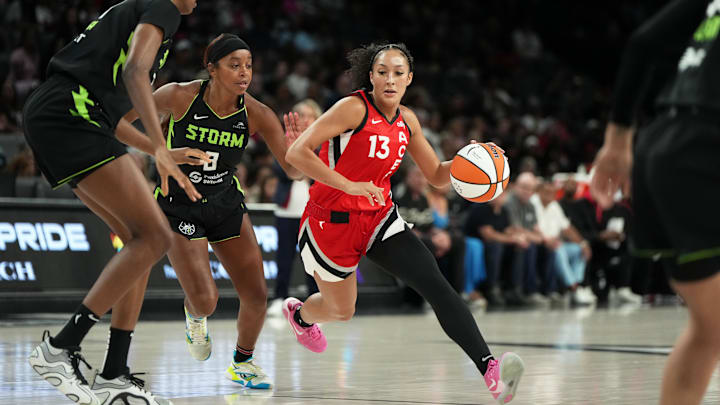 Jun 20, 2025; Las Vegas, Nevada, USA; Las Vegas Aces guard Aaliyah Nye (13) drives the ball against Seattle Storm guard Lexie Brown (8) during the first half of a WNBA basketball game at Michelob Ultra Arena.