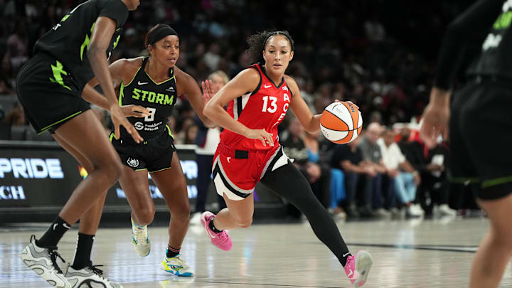 Jun 20, 2025; Las Vegas, Nevada, USA; Las Vegas Aces guard Aaliyah Nye (13) drives the ball against Seattle Storm guard Lexie Brown (8) during the first half of a WNBA basketball game at Michelob Ultra Arena. 