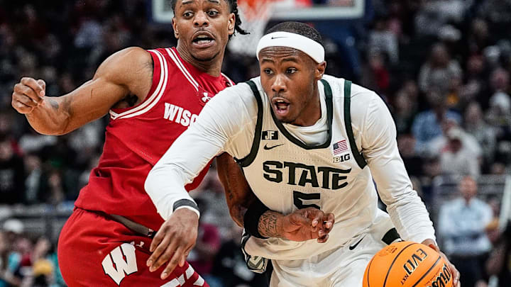 Michigan State guard Tre Holloman (5) dribbles against Wisconsin guard Kamari McGee (4) during the second half of Big Ten Tournament semifinal at Gainbridge Fieldhouse in Indianapolis, Ind. on Saturday, March 15, 2025.