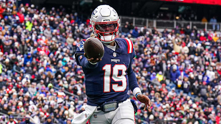 Jan 5, 2025; Foxborough, Massachusetts, USA; New England Patriots quarterback Joe Milton III (19) runs the ball for a touchdown against the Buffalo Bills in the first quarter at Gillette Stadium. Mandatory Credit: David Butler II-Imagn Images