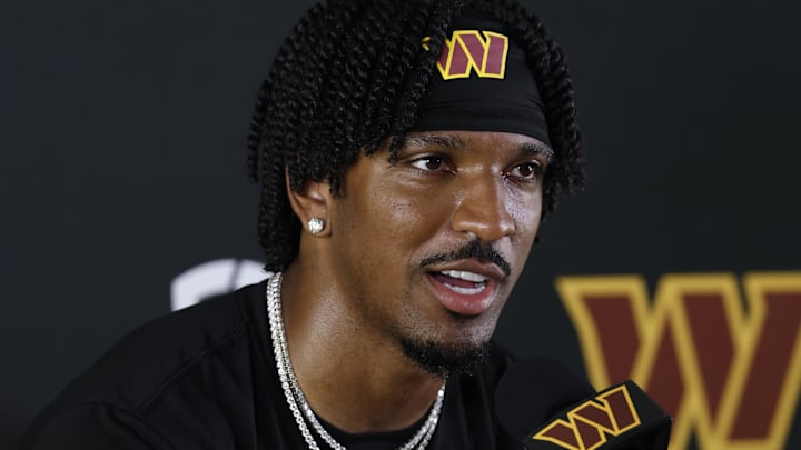 Jul 23, 2025; Ashburn, VA, USA; Washington Commanders quarterback Jayden Daniels (5) speaks with the media after practice on day one of training camp at OrthoVirginia Training Center at Commanders Park. Mandatory Credit: Geoff Burke-Imagn Images