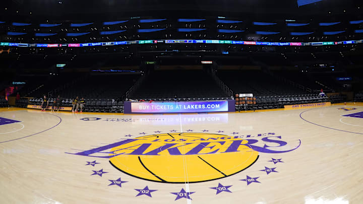 Apr 9, 2024; Los Angeles, California, USA; The Los Angeles Lakers logo at midcourt Crypto.com Arena. Mandatory Credit: Kirby Lee-Imagn Images