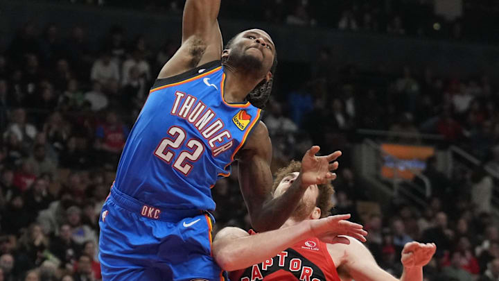 Dec 5, 2024; Toronto, Ontario, CAN; Oklahoma City Thunder guard Cason Wallace (22) makes a basket against Toronto Raptors forward Jamison Battle (77) during the second half at Scotiabank Arena. Mandatory Credit: John E. Sokolowski-Imagn Images