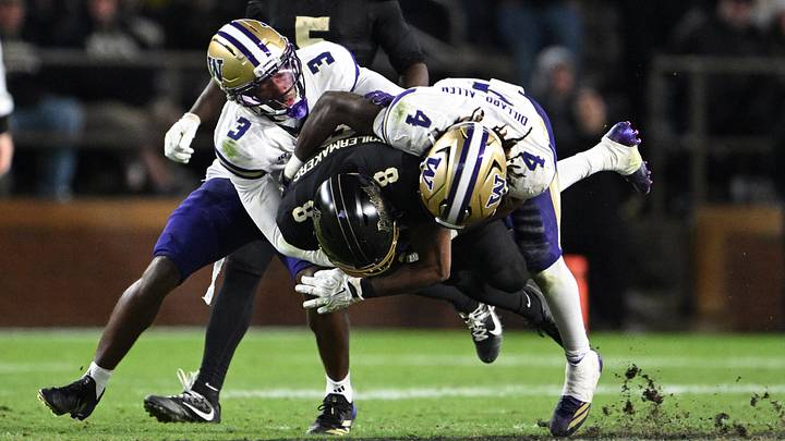 Huskies cornerback Emmanuel Karnley (3) and safety Rylon Dillard-Allen (4) bring down Purdue's De'nylon Morrissette. 