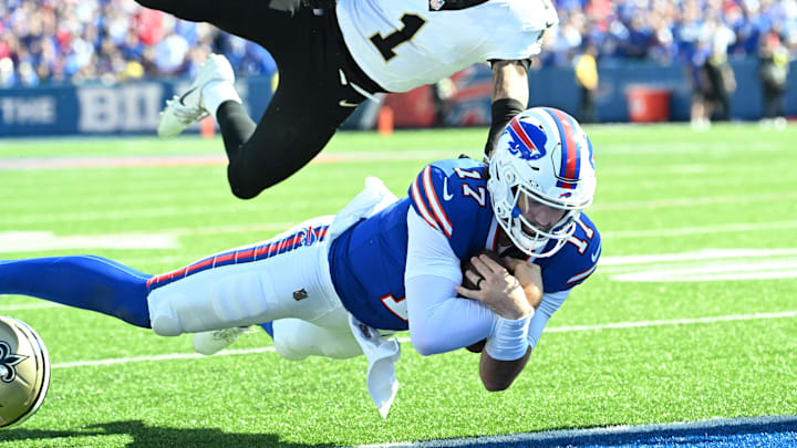Sep 28, 2025; Orchard Park, New York, USA;  Buffalo Bills quarterback Josh Allen (17) dives for a touchdown past New Orleans Saints cornerback Alontae Taylor (1) during the third quarter at Highmark Stadium. Mandatory Credit: Mark Konezny-Imagn Images